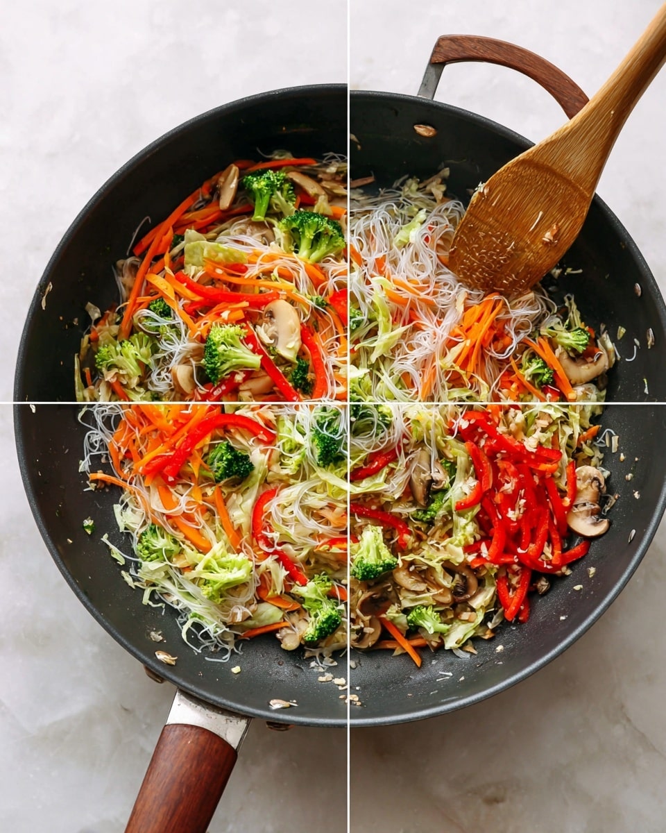 A dark frying pan with wooden handle sits on a white marbled surface. Inside, thin strips of light brown mushrooms and small pieces of minced garlic are the base layer. On top of this, there is a colorful mixture of thinly sliced orange carrots, bright green broccoli florets, shredded white cabbage, and red bell pepper strips arranged loosely. The pan is covered with a glass lid showing condensation over the vegetables inside. When the lid is removed, translucent white rice noodles mix evenly with the vegetables and mushrooms, creating a vibrant and fresh stir-fry with green, red, orange, white, and brown colors all visible. A wooden spatula is resting inside the pan stirring the cooked contents. Photo taken with an iphone --ar 4:5 --v 7